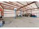Bright and spacious garage interior with a high ceiling and a car lift, perfect for automotive projects and ample storage space at 4602 W Monte Cristo Ave, Glendale, AZ 85306