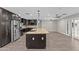 Spacious kitchen with an island, dark cabinets, stainless steel appliances, and light-colored tile flooring at 4602 W Monte Cristo Ave, Glendale, AZ 85306