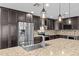Bright kitchen featuring an island with a sink, stainless steel appliances, and dark wood cabinets at 4602 W Monte Cristo Ave, Glendale, AZ 85306