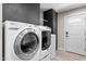 Laundry room with sleek appliances and a white door to the exterior at 4602 W Monte Cristo Ave, Glendale, AZ 85306
