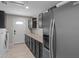 Laundry room with sleek cabinets, ample counter space, and modern appliances at 4602 W Monte Cristo Ave, Glendale, AZ 85306