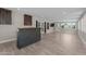 Basement living room with a bar, cabinets, exterior access doors, and wood-look tile floors at 4602 W Monte Cristo Ave, Glendale, AZ 85306