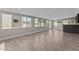 Basement living room featuring a bar, multiple windows, and wood-look tile flooring at 4602 W Monte Cristo Ave, Glendale, AZ 85306