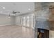 Open living area features wood-look tile flooring, fireplace with stone surround, and backyard access at 4602 W Monte Cristo Ave, Glendale, AZ 85306
