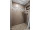 Shower featuring decorative tile, tile flooring, and built-in shelves at 4602 W Monte Cristo Ave, Glendale, AZ 85306