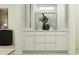 Bathroom featuring double vanity sinks, white cabinetry, and a framed mirror at 4808 S 232Nd Ln, Buckeye, AZ 85326
