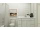 Bright bathroom featuring a sleek vanity, decorative art, and a modern toilet design at 4808 S 232Nd Ln, Buckeye, AZ 85326