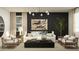 Modern living room with designer lighting, neutral furniture, and ample natural light at 4808 S 232Nd Ln, Buckeye, AZ 85326