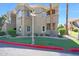 A three-story building with a stucco exterior, palm trees, and well-maintained landscaping at 5335 E Shea Blvd # 1087, Scottsdale, AZ 85254