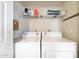 Functional laundry room featuring white washer and dryer and storage shelves above at 5335 E Shea Blvd # 1087, Scottsdale, AZ 85254