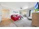 Open-concept living room featuring a red sofa, ceiling fan, decor, and access to a patio at 5335 E Shea Blvd # 1087, Scottsdale, AZ 85254