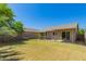 A fenced backyard offering ample space with some nice bushes and palm trees at 5401 W Jessica Ln, Laveen, AZ 85339