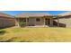 Charming home featuring a spacious backyard with well-maintained lawn and a covered patio area at 5401 W Jessica Ln, Laveen, AZ 85339