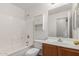 Bathroom featuring a combined shower and bathtub, next to the toilet and vanity at 5401 W Jessica Ln, Laveen, AZ 85339