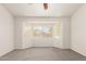 Spacious bedroom with carpeted floors and a large bright window at 5401 W Jessica Ln, Laveen, AZ 85339