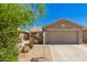 Charming single-story home with a two-car garage and a well-manicured front yard with desert landscaping at 5401 W Jessica Ln, Laveen, AZ 85339