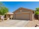 Charming single-story home with a two-car garage and a well-manicured front yard and walkway at 5401 W Jessica Ln, Laveen, AZ 85339