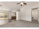 Open floor plan with neutral paint, carpet and tile flooring and sliding glass door to outside patio at 5401 W Jessica Ln, Laveen, AZ 85339