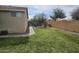 Green backyard with lush lawn, garden beds, and a sturdy privacy fence at 5616 W Hidalgo Ave, Laveen, AZ 85339
