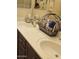 Bathroom featuring double sinks with an assortment of decorative items and storage basket at 5616 W Hidalgo Ave, Laveen, AZ 85339