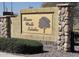 River Walk Estates community entrance featuring a stone and stucco sign and manicured landscaping at 5616 W Hidalgo Ave, Laveen, AZ 85339