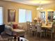 Elegant dining area featuring a chandelier, a china cabinet, and a large dining table at 5616 W Hidalgo Ave, Laveen, AZ 85339