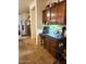 Kitchen desk nook with dark wood cabinets, stone countertops, and decorative overhead lighting at 5616 W Hidalgo Ave, Laveen, AZ 85339