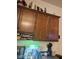 Close up of office nook, dark wood cabinets, with stone countertops and decor on top of the cabinets at 5616 W Hidalgo Ave, Laveen, AZ 85339