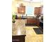 Traditional kitchen with stone countertops, stainless steel appliances, and tile flooring at 5616 W Hidalgo Ave, Laveen, AZ 85339