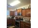Traditional kitchen with stone countertops, stainless steel appliances, and tile flooring at 5616 W Hidalgo Ave, Laveen, AZ 85339