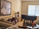 Inviting living room with comfortable seating, a decorative print, and a grand piano at 5616 W Hidalgo Ave, Laveen, AZ 85339