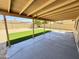 Spacious covered patio with concrete, with artificial turf and beige house and wall at 6419 W Monte Cristo Ave, Glendale, AZ 85306