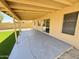 Spacious covered patio with concrete, with artificial turf and beige house and wall at 6419 W Monte Cristo Ave, Glendale, AZ 85306