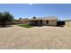 Spacious backyard with desert landscaping and a covered patio at 6419 W Monte Cristo Ave, Glendale, AZ 85306