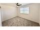 Spacious bedroom with soft gray carpet, a ceiling fan and bright window at 6419 W Monte Cristo Ave, Glendale, AZ 85306