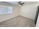 Bright bedroom with new carpet, ceiling fan, and window with blinds at 6419 W Monte Cristo Ave, Glendale, AZ 85306