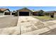 View of home exterior featuring driveway, neutral color scheme, and attached garage at 6419 W Monte Cristo Ave, Glendale, AZ 85306