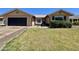 Charming single-story home with a manicured lawn, black garage door, and inviting front entrance at 6419 W Monte Cristo Ave, Glendale, AZ 85306