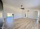 Living room featuring hard surface floors, ceiling fan, open floorplan and sliding glass door to backyard at 6419 W Monte Cristo Ave, Glendale, AZ 85306