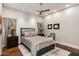 Comfortable bedroom with neutral paint, wood floors, a ceiling fan, and an upholstered headboard at 6512 N 31St Way, Phoenix, AZ 85016