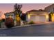 Well-lit home exterior showcases desert landscaping, steps to front entry and three-car garage at 6512 N 31St Way, Phoenix, AZ 85016