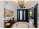 Grand foyer featuring soaring ceilings, a chandelier, a rug, and an ornate front door with side lights at 6512 N 31St Way, Phoenix, AZ 85016