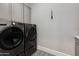 Laundry room featuring side by side appliances, neutral walls, and patterned flooring at 6512 N 31St Way, Phoenix, AZ 85016