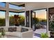 Living room view to outdoor spa and desert landscape with views of mountains in the distance at 6512 N 31St Way, Phoenix, AZ 85016