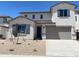 Charming two-story home boasts a modern exterior, desert landscaping, and a two-car garage at 7216 E Blissful Breeze Ln, San Tan Valley, AZ 85143