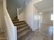 Bright foyer offers a staircase with white railing, neutral walls, and access to other rooms at 7216 E Blissful Breeze Ln, San Tan Valley, AZ 85143