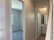 Hallway features views of a bedroom and bathroom with carpet and tile flooring at 7216 E Blissful Breeze Ln, San Tan Valley, AZ 85143