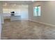 Spacious living room with neutral tile flooring, ample natural light, and an open-concept layout at 7216 E Blissful Breeze Ln, San Tan Valley, AZ 85143