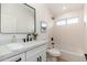 Clean bathroom featuring a modern vanity, sleek mirror, and tiled shower-tub combination at 7223 N 14Th St, Phoenix, AZ 85020