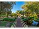 Charming wooden bridge over a tranquil pond with lush greenery, creating a serene and picturesque setting at 7223 N 14Th St, Phoenix, AZ 85020